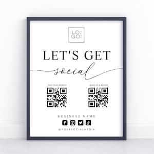 May include: A framed white sign with black text that reads "LET'S GET social." It includes a logo, QR codes, social media icons, and the text "VISIT OUR WEBSITE," "LEAVE US A REVIEW," "BUSINESS NAME," and "@YOURSOCIALMEDIA."