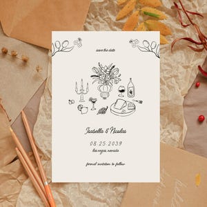 Peut inclure: Une carte de sauvegarde de la date avec une illustration en noir et blanc d'un bouquet de fleurs, des bougies, des verres à vin et un plateau de fromage. Le texte indique "save the date", "Isabella & Nicolas", "08.25.2039", "las vegas, nevada" et "formal invitation to follow".