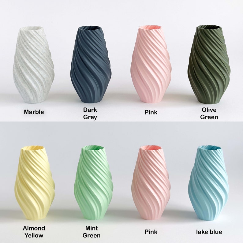 May include: Eight ceramic vases in various colors, including marble, dark grey, pink, olive green, almond yellow, mint green, lake blue, and pink. The vases are all the same shape, with a twisted, swirling design.