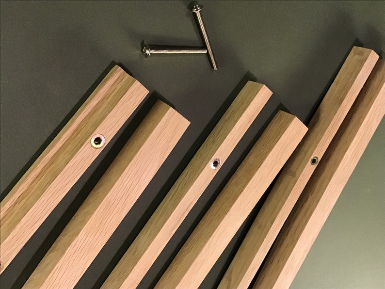 May include: Five wooden pieces with pre-drilled holes and metal screws. The wood is a light brown colour.