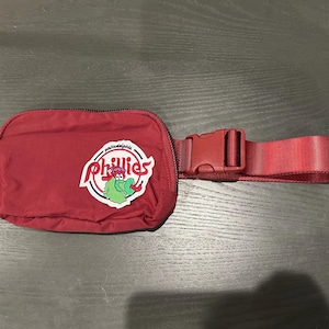 Phillies maroon belt bag with embroidered retro Phanatic patch. Bag is approximately 8”x5”x2”