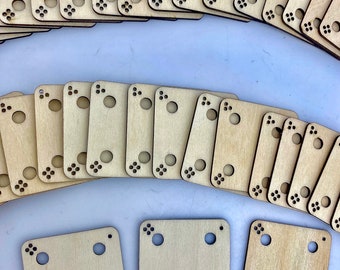 May include: A set of wooden tiles with rounded corners and multiple holes. The tiles are arranged in a semi-circle pattern. There are three additional tiles in the bottom center of the image.