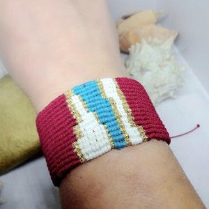 Woven handmade macrame bracelet in red, turquoise, white and gold cord, for all occasions. Unique gift for you or the one you love.
