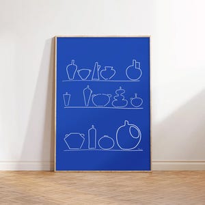 May include: A framed art print featuring a blue background with white line drawings of various pottery pieces arranged on shelves. The artwork showcases a minimalist design with a focus on form and shape, suitable for home decor.