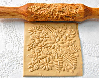 rolling pin with a pattern of flowers for dough and clay