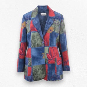 May include: A vintage blazer with a patchwork design in shades of blue, red, and green. The blazer has a single-button closure, notched lapels, and two front pockets. The fabric features a leaf pattern.