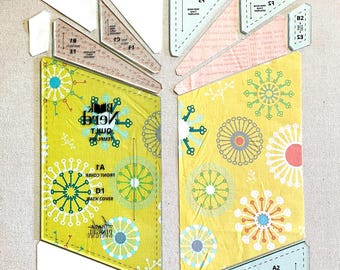 May include: A set of clear plastic quilting templates with various shapes and sizes. The templates are labeled with letters and numbers, and include instructions for a quilt project called "Book Nerd Quilt Templates".