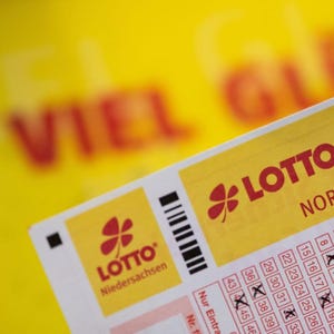 May include: A yellow lottery ticket with the text "LOTTO 6aus49" and "NORMAL" printed on it. The ticket has a clover logo and the text "LOTTO Niedersachsen".