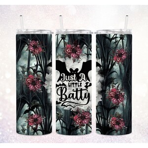 May include: Three stainless steel tumblers with a black and white bat graphic and the text "Just a little Batty". The tumblers have a floral design with dark green leaves and pink flowers.