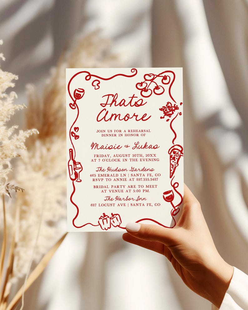 May include: Red and white invitation card with a red border and illustrations of food and wine. The text reads "Thato Amore" and includes the names "Maisie & Lukas" and the details for a rehearsal dinner.