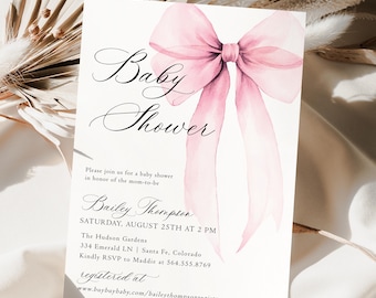 May include: A white rectangular baby shower invitation card featuring a large watercolor pink bow. The text reads: Baby Shower, Please join us for a baby shower in honor of the mom-to-be, Bailey Thompson, Saturday, August 25th at 2 PM.
