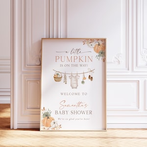 May include: A rectangular poster measuring 18x24 inches featuring the text A little PUMPKIN IS ON THE WAY! WELCOME TO Samantha's BABY SHOWER We're so glad you're here! with illustrations of pumpkins, a basket, a baby onesie, and shoes.