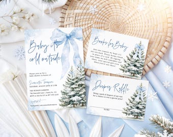 May include: A baby shower invitation set featuring a blue watercolor bow and snowy pine trees. The text reads Baby it's cold outside, Books for Baby, and Diaper Raffle, with details for Samantha Thompson at The Hudson Gardens on August 20th.