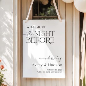 Pu&ograve; includere: Un cartello bianco con la scritta "WELCOME TO the NIGHT BEFORE celebrating Avery & Hudson OCTOBER 10, 2026 WE'RE SO GLAD YOU'RE HERE!" &egrave; appeso a una porta bianca. Il cartello &egrave; sospeso da nastri color crema. Palloncini in alto.