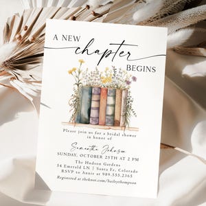 May include: A white bridal shower invitation with a watercolor illustration of a stack of books and flowers. The text reads "A New Chapter Begins" and includes the bride's name, date, time, and location.