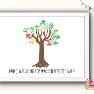 May include: A white framed print with a colorful tree made of handprints. The tree has green, red, and yellow leaves. The text "DANKE, DASS SIE UNS BEIM WACHSEN BEGLEITET HABEN!" is at the bottom of the print.