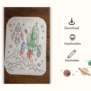 May include: A black and white coloring page featuring two rockets taking off into space. The rockets are outlined and ready to be colored in. The page also includes stars and clouds.