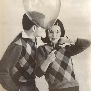 May include: A black and white photograph of a couple wearing matching diamond patterned jumpers. The couple are holding a heart-shaped balloon.