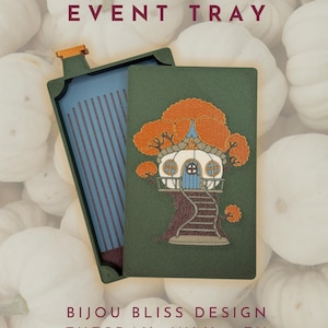 May include: A rectangular green tray with a lid featuring a treehouse illustration with orange foliage and a blue door. The tray interior is blue with vertical ridges. Text reads: CHERYL BAKER EVENT TRAY, BIJOU BLISS DESIGN, TUESDAY, JULY 14TH, 4PM MST, MADE-TO-ORDER.