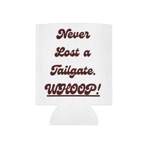May include: White can cooler with the text "Never Lost a Tailgate. WHOOP!" in brown lettering.