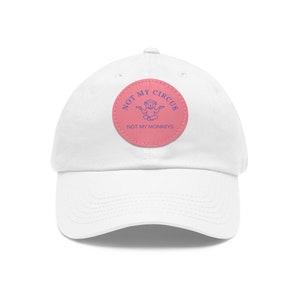 May include: White baseball cap with a pink patch that says "Not My Circus, Not My Monkeys" with a blue monkey illustration.