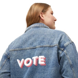 May include: A blue denim jacket with the word "VOTE" printed in white and red on the back.