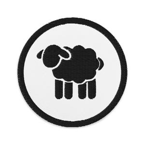 May include: Black and white embroidered patch of a sheep in a circle. The sheep is black and the circle is white with a black outline.