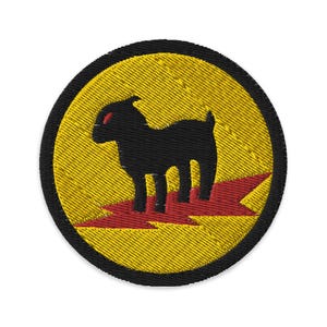 May include: A black and yellow embroidered patch with a black goat standing on a red lightning bolt.