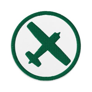 May include: A green embroidered patch with a white circle and a green airplane silhouette inside.