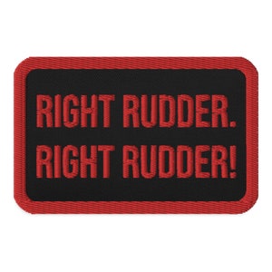 May include: Red embroidered patch with black background and the text "RIGHT RUDDER. RIGHT RUDDER!"