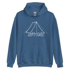 May include: Blue hooded sweatshirt with a white tent graphic and the words "KEEP IT SIMPLE." The hoodie has a front pocket and a drawstring hood. The graphic features a simple tent design with grass and flowers.