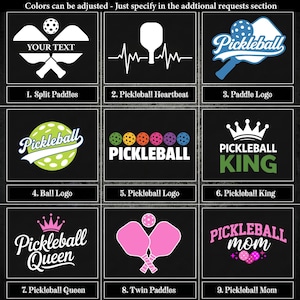 a collection of nine different pickleball logos and designs that can be customized onto your bag. The logos and designs include split paddles, a heartbeat, a paddle logo, a "Pickleball King" logo, a "Pickleball Queen" logo, a "Twin Paddles" logo, and a "Pickleball Mom" logo. The logos and designs are presented in a grid format, with each one featuring a unique color scheme and style.