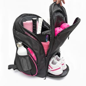 Pink pickleball backpack with ball storage, water bottle mesh pocket, shoe container, and plenty more room. Large and spacious bag.