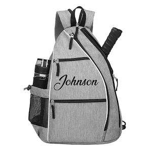 A gray and black sports backpack with the name "Johnson" printed on it.