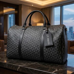 A black duffel bag with a geometric pattern sits on a marble countertop in a hotel room, with a city skyline visible through the window.