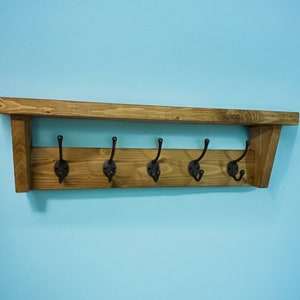 Rustic Solid Pine wooden coat rack in a farmhouse style with shelf and Heavy duty cast iron coat hooks available with different wax finishes