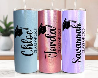 May include: Three stainless steel tumblers with glitter finishes. The tumblers are blue, pink, and purple. Each tumbler has a graduation cap design and the text "Class of 2025" with a name below: Chloe, Jorda, and Savannah.