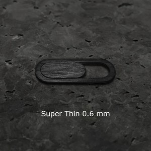 May include: Black webcam cover with a sliding mechanism. Super Thin 0.6 mm.