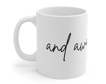 May include: White ceramic mug with a curved handle. The mug features the handwritten text "and away" in black cursive script. The mug is designed for hot beverages and is suitable for home or office use.