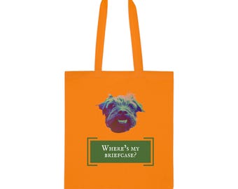 May include: Orange tote bag with a dog graphic and the text "WHERE'S MY BRIEFCASE?" The dog graphic is a close-up of a dog's face with a colorful, stylized design. The bag has orange handles.