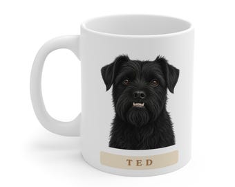 May include: A white ceramic mug featuring a detailed illustration of a black dog with brown eyes and visible teeth. Below the dog, a beige horizontal rectangular label contains the name TED printed in brown capital letters.