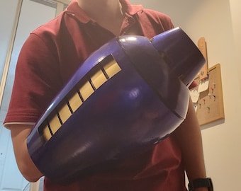May include: A blue and gold plastic arm prop with a textured surface. The arm prop is designed to look like a robot arm.
