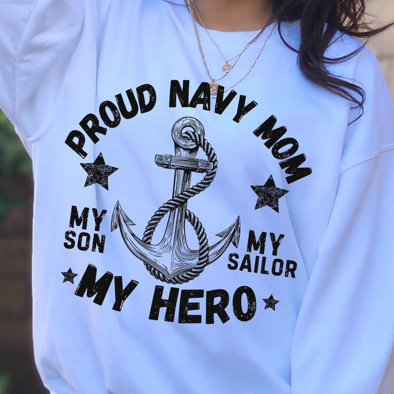 May include: White sweatshirt with the text "PROUD NAVY MOM" in a circular design around a black and white anchor graphic. The text "MY SON MY SAILOR MY HERO" is also included, along with star graphics.