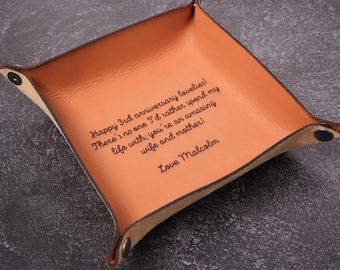 May include: A brown leather tray with a personalized message: "Happy 3rd anniversary lovelies! There's no one I'd rather spend my life with; you're an amazing wife and mother! Love Malcolm"