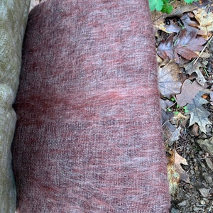 May include: A soft, brown and gray woven shawl with a fuzzy texture.