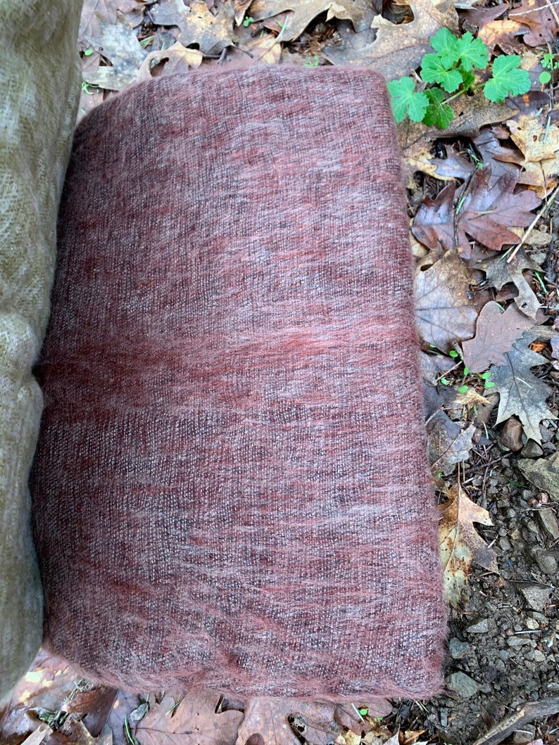 May include: A soft, brown and gray woven shawl with a fuzzy texture.