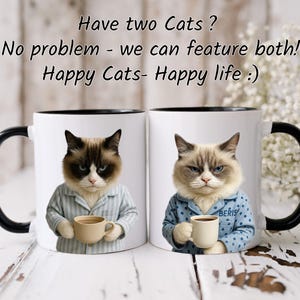 May include: Two white ceramic mugs with black handles and rims. Each mug features a cat wearing pajamas and holding a coffee cup. Text on the mugs reads "Have two Cats? No problem - we can feature both! Happy Cats- Happy life :)"
