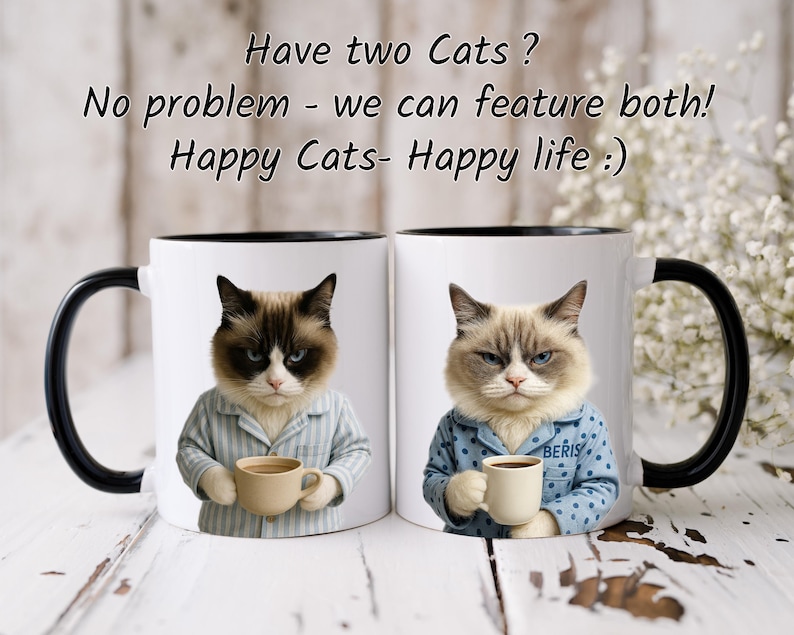 May include: Two white ceramic mugs with black handles and rims. Each mug features a cat wearing pajamas and holding a coffee cup. Text on the mugs reads "Have two Cats? No problem - we can feature both! Happy Cats- Happy life :)"