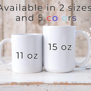 May include: Two white ceramic mugs, one labeled "11 oz" and the other "15 oz", are displayed. The text "Available in 2 sizes and 5 colors" is at the top. The mugs have large handles and are set against a light wood background.