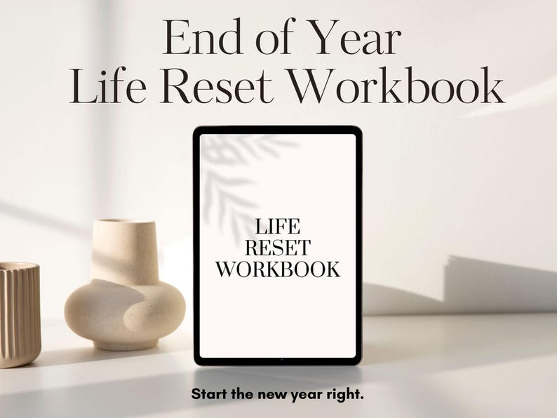 May include: A digital tablet displaying a white screen with the text "Life Reset Workbook" and the words "Start the new year right."  The tablet is on a white surface with two beige ceramic vases.